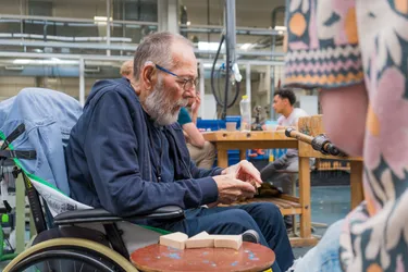 Vitalis resident handles a student's scale model of their project and gives feedback