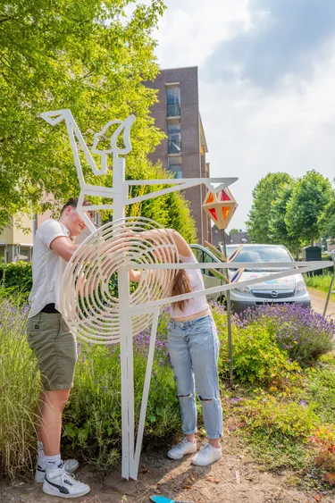 Students work together to put the final touches on the Swan Lake sculpture