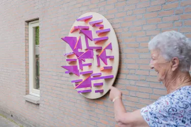 Vitalis Resident inspecting Ryan van Wijk's Illusion Wall Art
