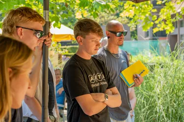 Students inspecting one of the pieces of work