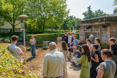 Students gather to see a presentation of a sculpture