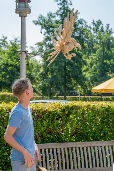 Student admiring bird sculpture