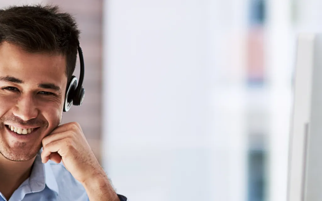 Image of a man with a headset taking a call