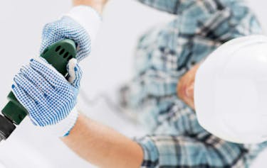 Image of a builder drilling a hole